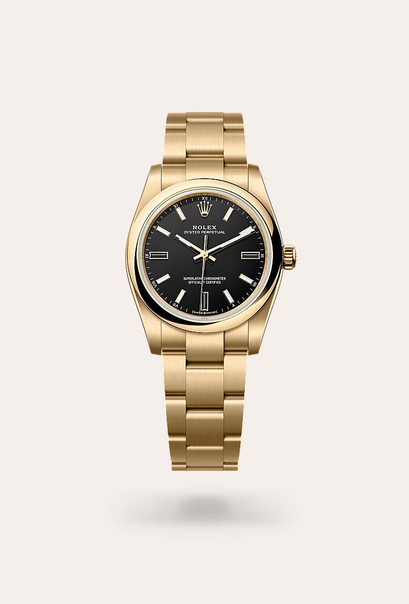Rolex Oyster Perpetual 34 in 18 ct yellow gold with a black dial, domed bezel, and Oyster bracelet.