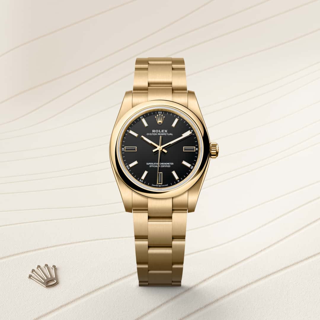 Rolex Oyster Perpetual 34 in 18 ct yellow gold with a black dial, domed bezel, and Oyster bracelet.