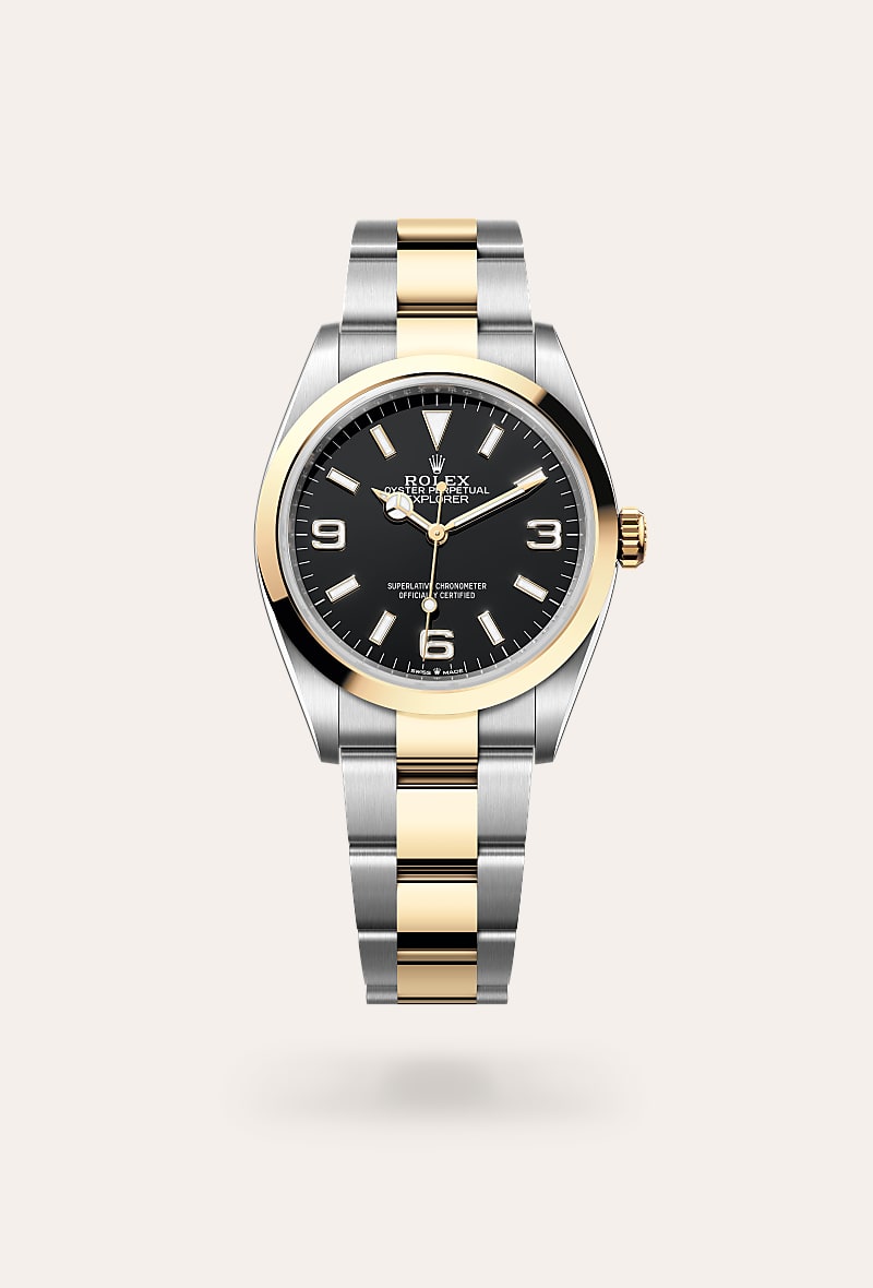 Rolex Explorer 36 in Yellow Rolesor with a black dial, smooth bezel, and Oyster bracelet.