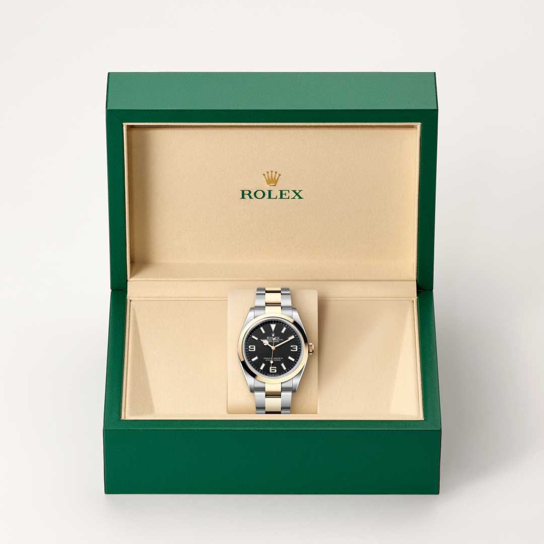 Rolex Explorer 36 in Yellow Rolesor with a black dial, smooth bezel, and Oyster bracelet.