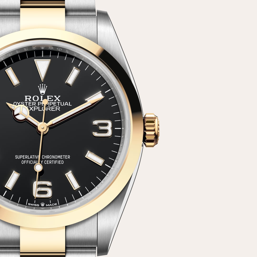 Rolex Explorer 36 in Yellow Rolesor with a black dial, smooth bezel, and Oyster bracelet.