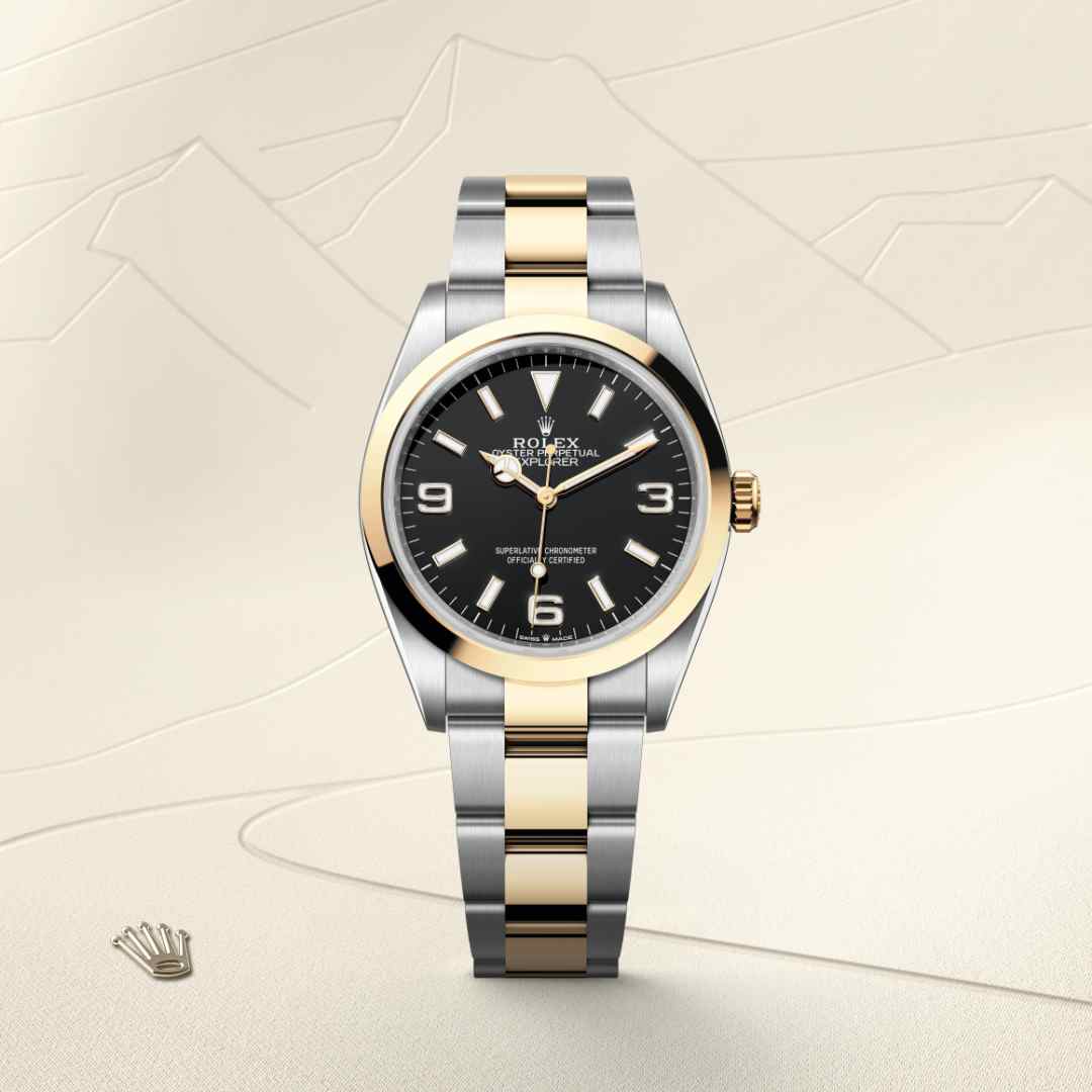 Rolex Explorer 36 in Yellow Rolesor with a black dial, smooth bezel, and Oyster bracelet.