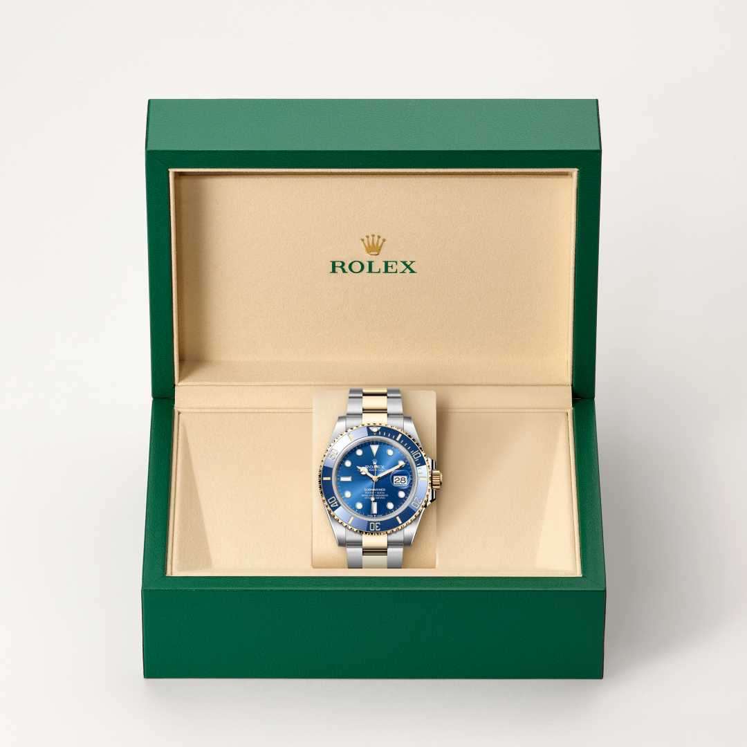 Rolex Submariner Date in Yellow Rolesor with a royal blue dial, unidirectional rotatable 60-minute graduated, scratch-resistant cerachrom insert in blue ceramic, numerals and graduations coated in gold bezel, and Oyster bracelet.