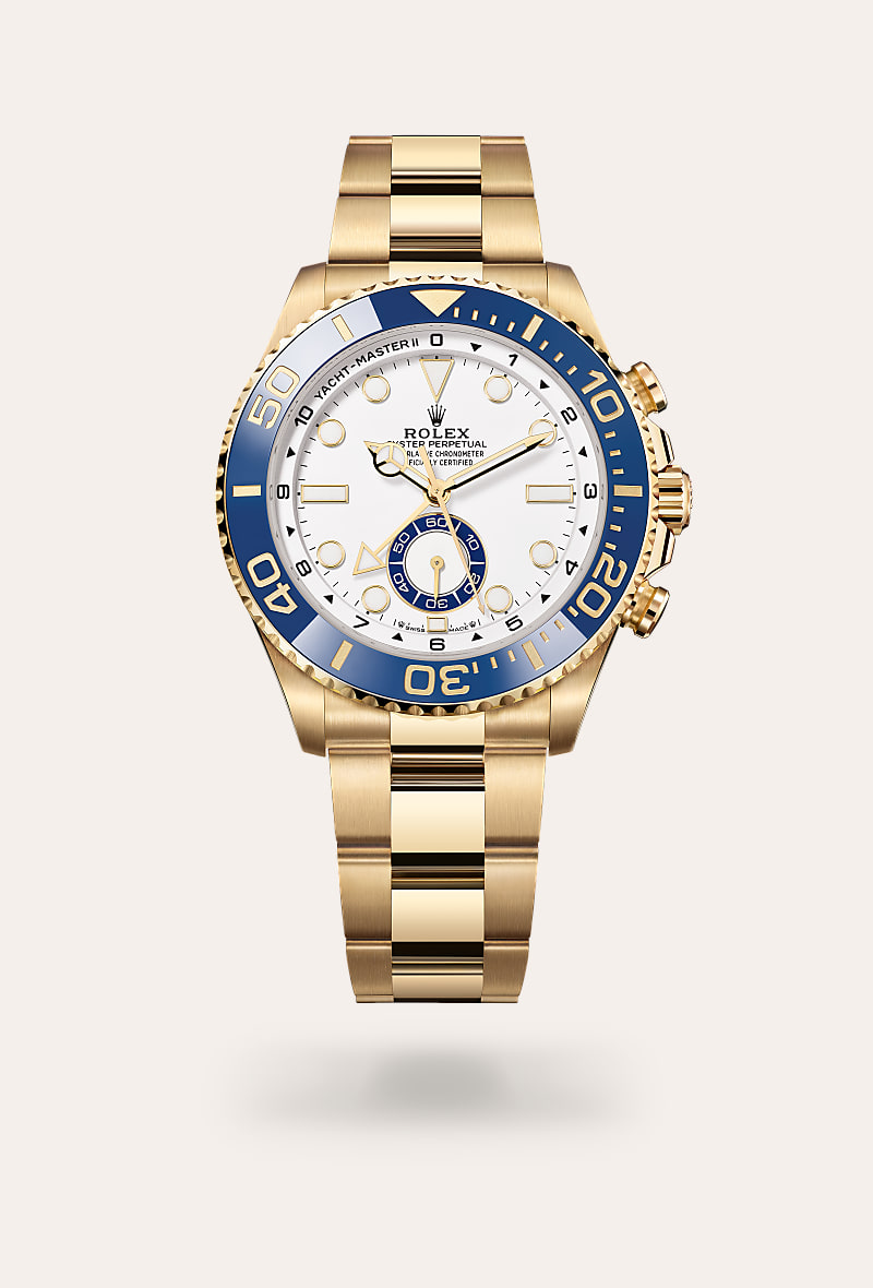 Rolex Yacht-Master II in 18 ct yellow gold with a white dial, bidirectional rotatable 60-minute graduated bezel with blue cerachrom insert in ceramic. moulded, recessed graduations and numerals coated with gold bezel, and Oyster bracelet.