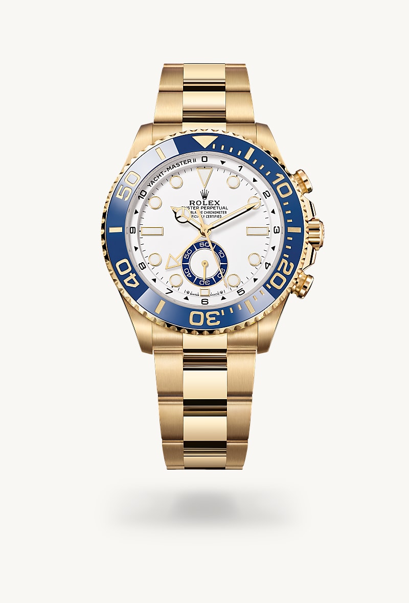 Rolex Yacht-Master II in 18 ct yellow gold with a white dial, bidirectional rotatable 60-minute graduated bezel with blue cerachrom insert in ceramic. moulded, recessed graduations and numerals coated with gold bezel, and Oyster bracelet.