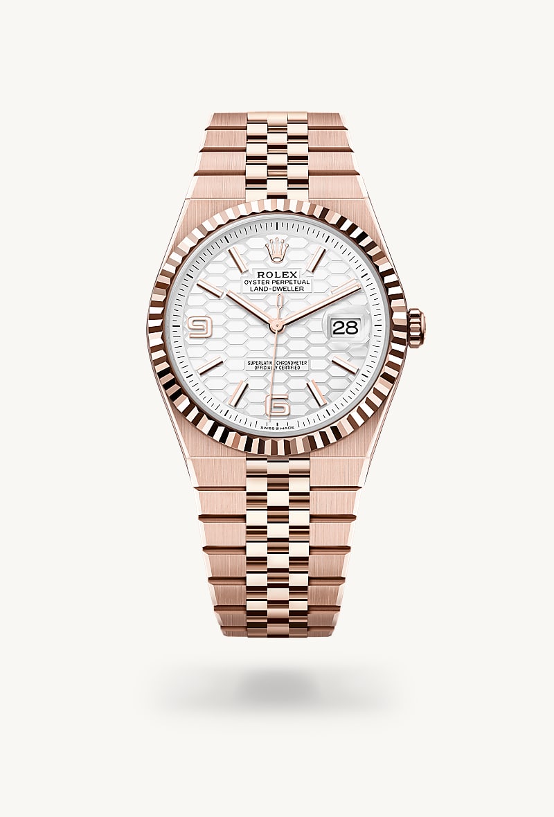 Rolex Land-Dweller 40 in 18 kt Everose gold with a intense white, honeycomb motif dial, fluted bezel, and Flat Jubilee bracelet.