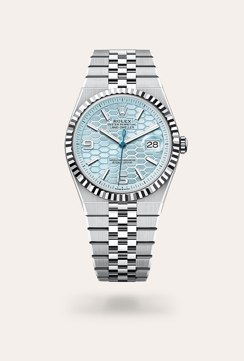 Rolex Land-Dweller 40 in Platinum with a ice blue, honeycomb motif dial, fluted bezel, and Flat Jubilee bracelet.