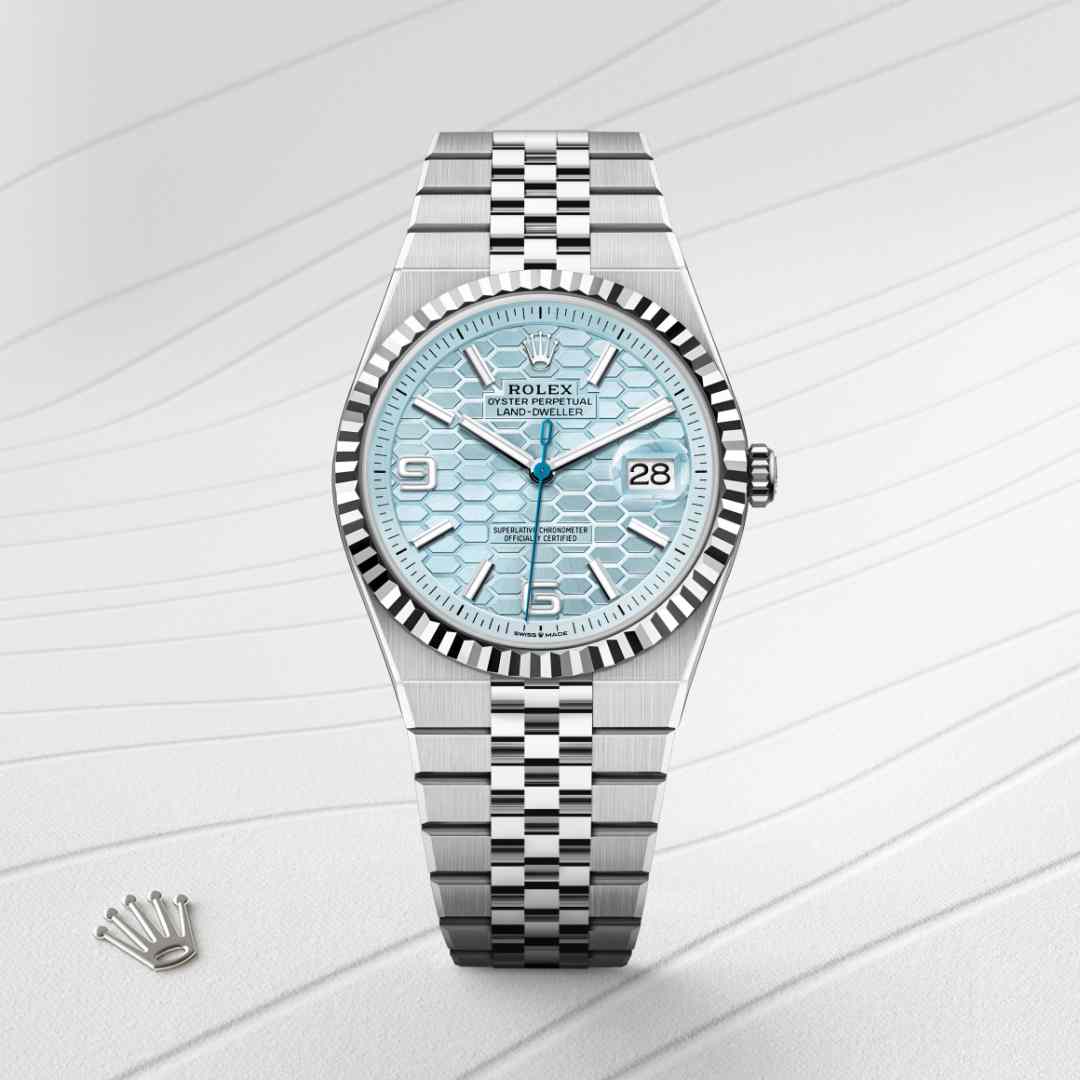 Rolex Land-Dweller 40 in Platinum with a ice blue, honeycomb motif dial, fluted bezel, and Flat Jubilee bracelet.