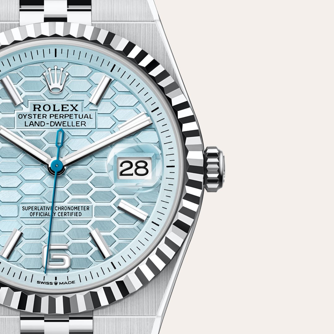 Rolex Land-Dweller 40 in Platinum with a ice blue, honeycomb motif dial, fluted bezel, and Flat Jubilee bracelet.