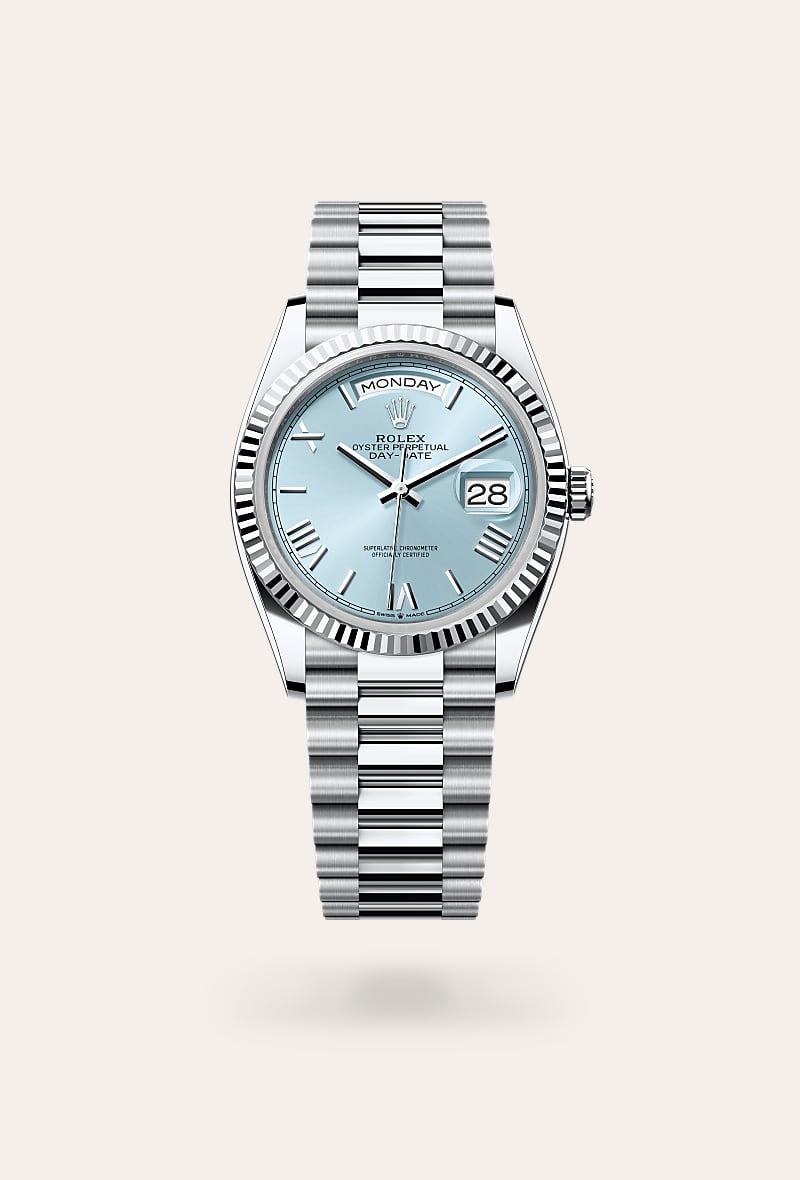 Rolex Day-Date 36 in Platinum with a ice blue dial, fluted bezel, and President bracelet.