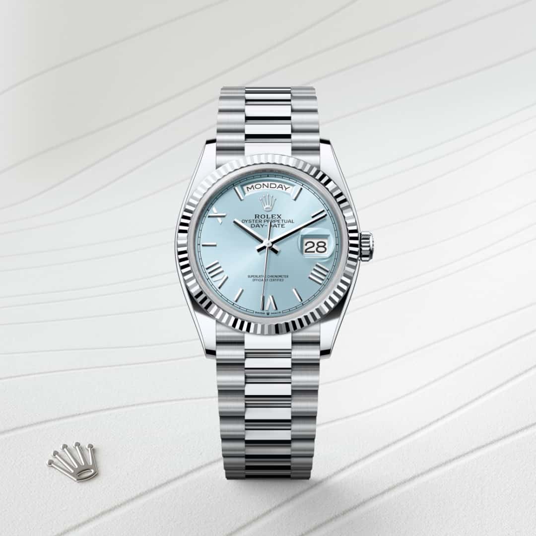 Rolex Day-Date 36 in Platinum with a ice blue dial, fluted bezel, and President bracelet.