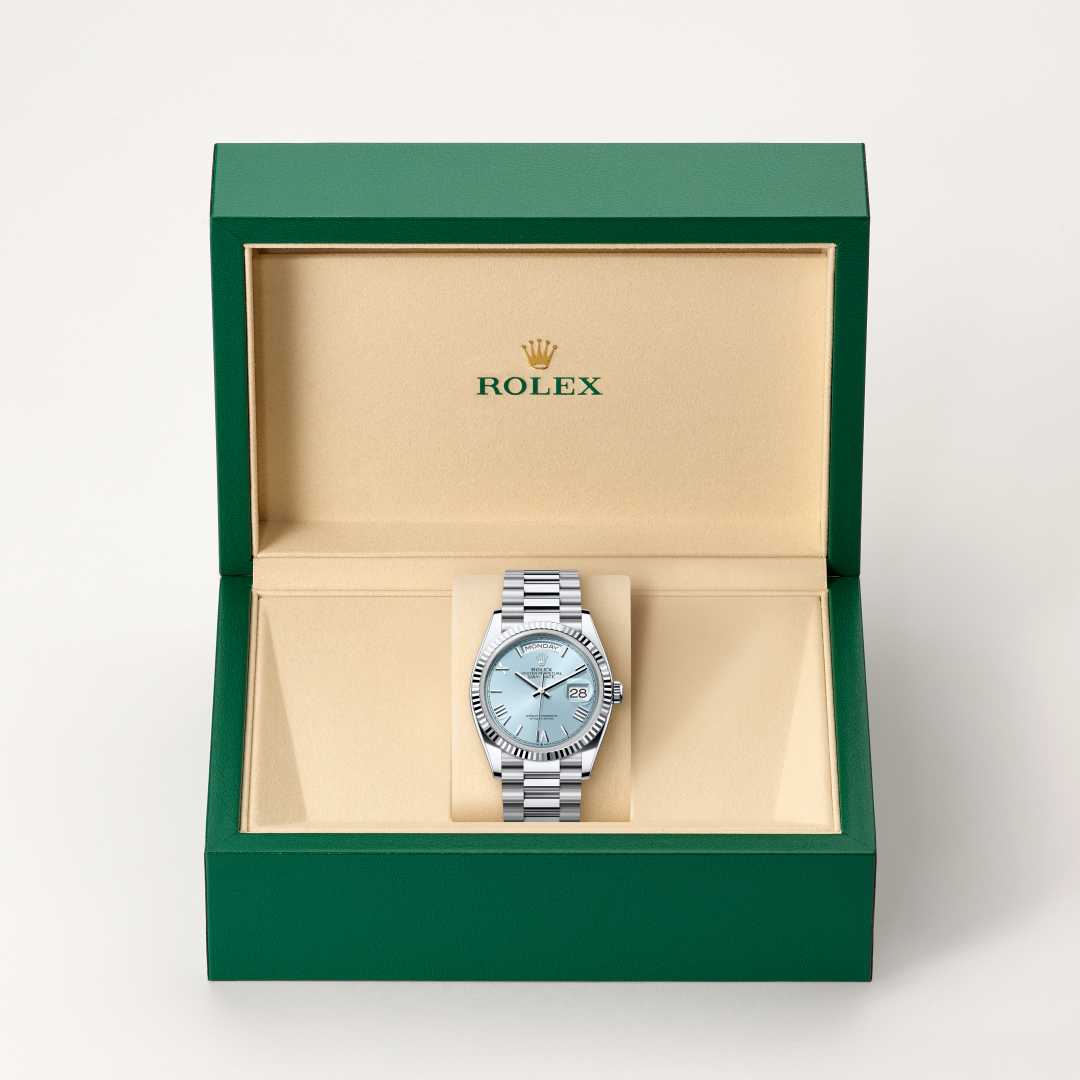 Rolex Day-Date 36 in Platinum with a ice blue dial, fluted bezel, and President bracelet.