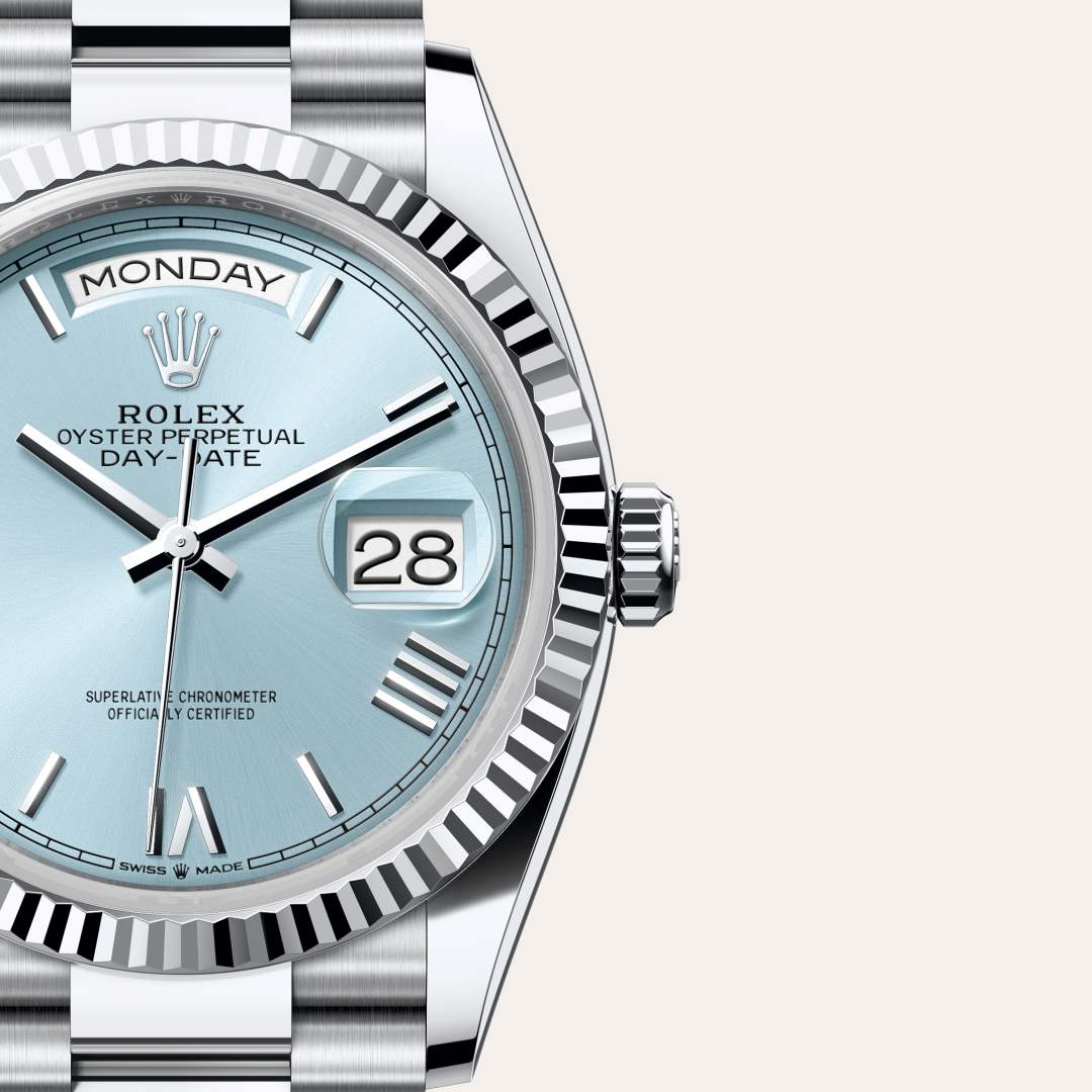 Rolex Day-Date 36 in Platinum with a ice blue dial, fluted bezel, and President bracelet.