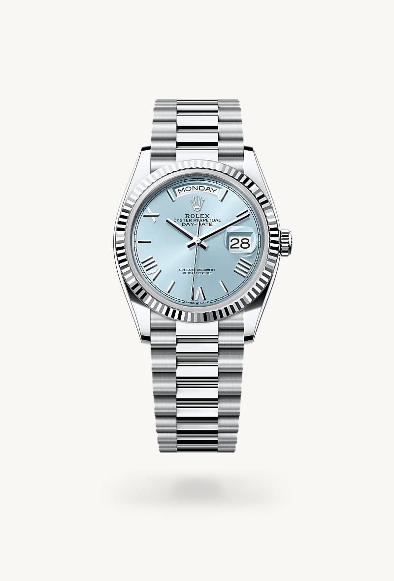 Rolex Day-Date 36 in Platinum with a ice blue dial, fluted bezel, and President bracelet.