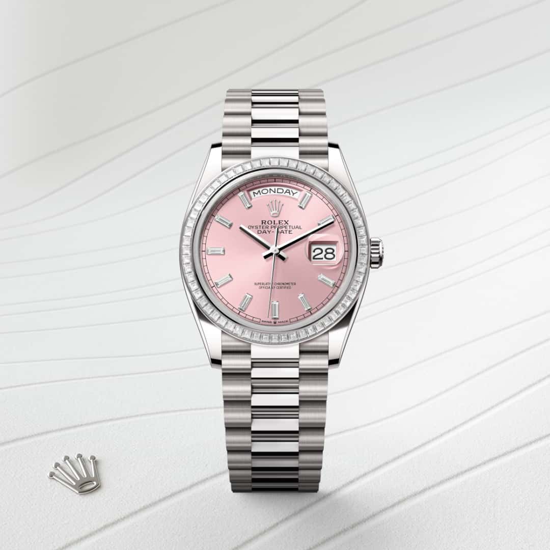 Rolex Day-Date 36 in 18 kt white gold with a pink set with diamonds dial, set with diamonds bezel, and President bracelet.