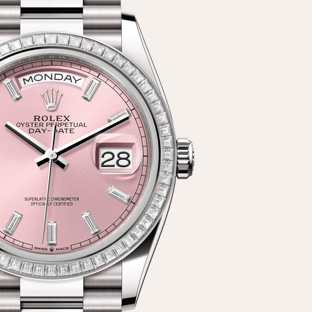 Rolex Day-Date 36 in 18 kt white gold with a pink set with diamonds dial, set with diamonds bezel, and President bracelet.