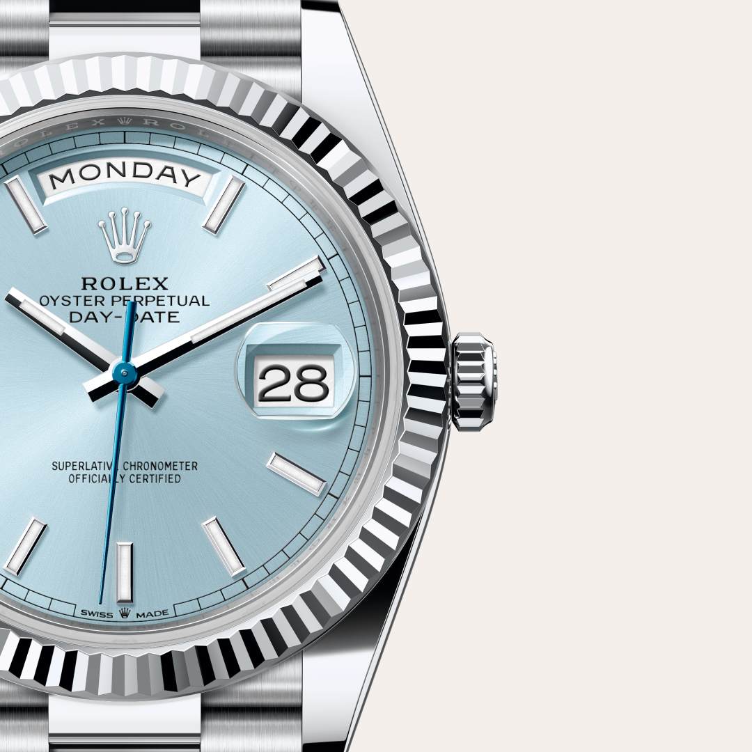 Rolex Day-Date 40 in Platinum with a ice blue dial, fluted bezel, and President bracelet.