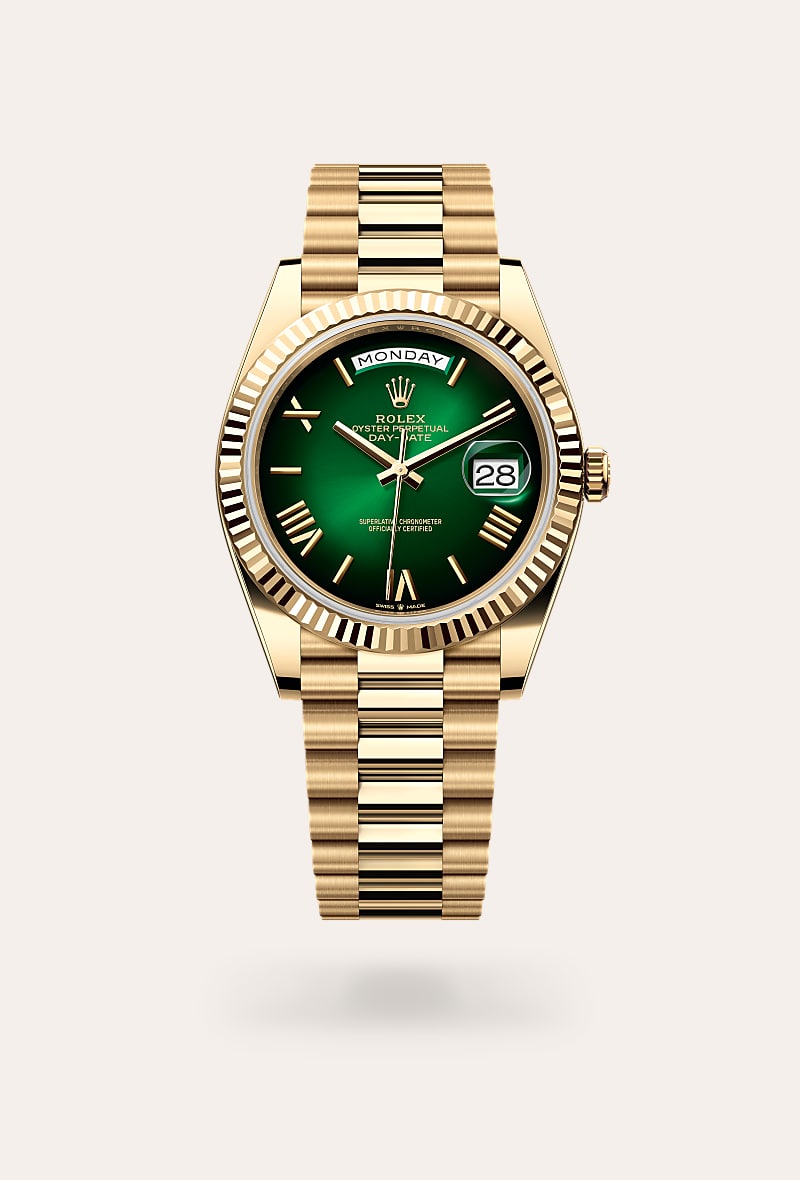Rolex Day-Date 40 in 18 kt yellow gold with a green ombr&eacute; dial, fluted bezel, and President bracelet.