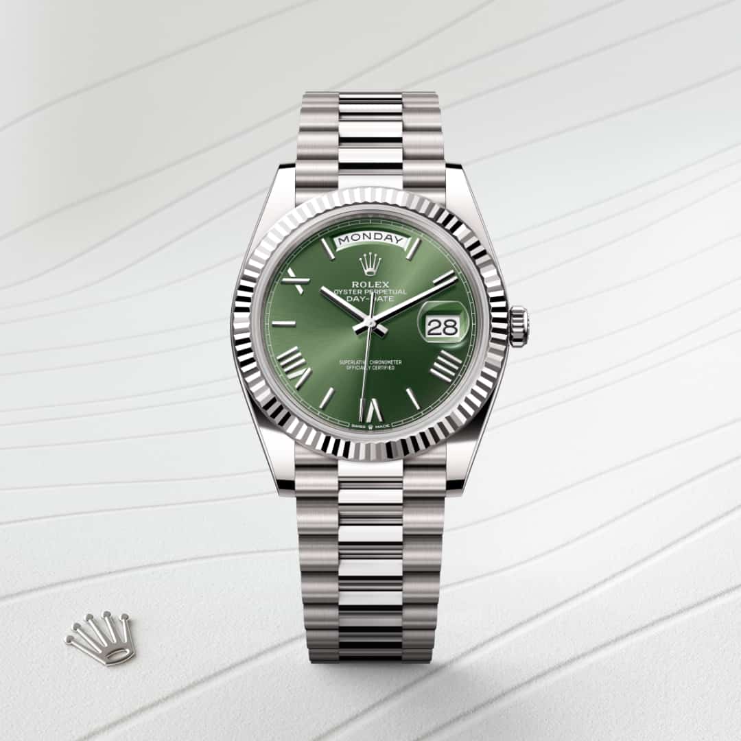 Rolex Day-Date 40 in 18 kt white gold with a olive green dial, fluted bezel, and President bracelet.