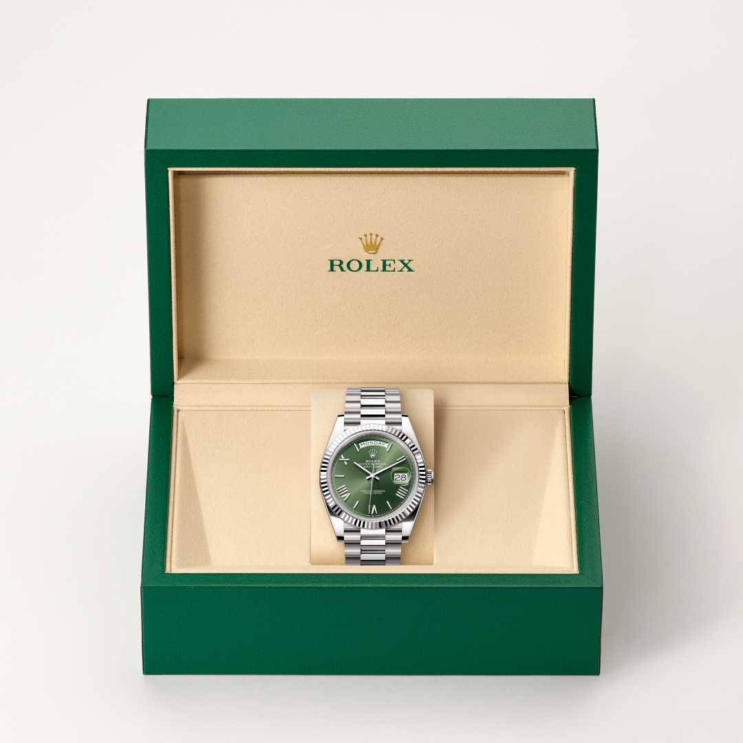 Rolex Day-Date 40 in 18 kt white gold with a olive green dial, fluted bezel, and President bracelet.