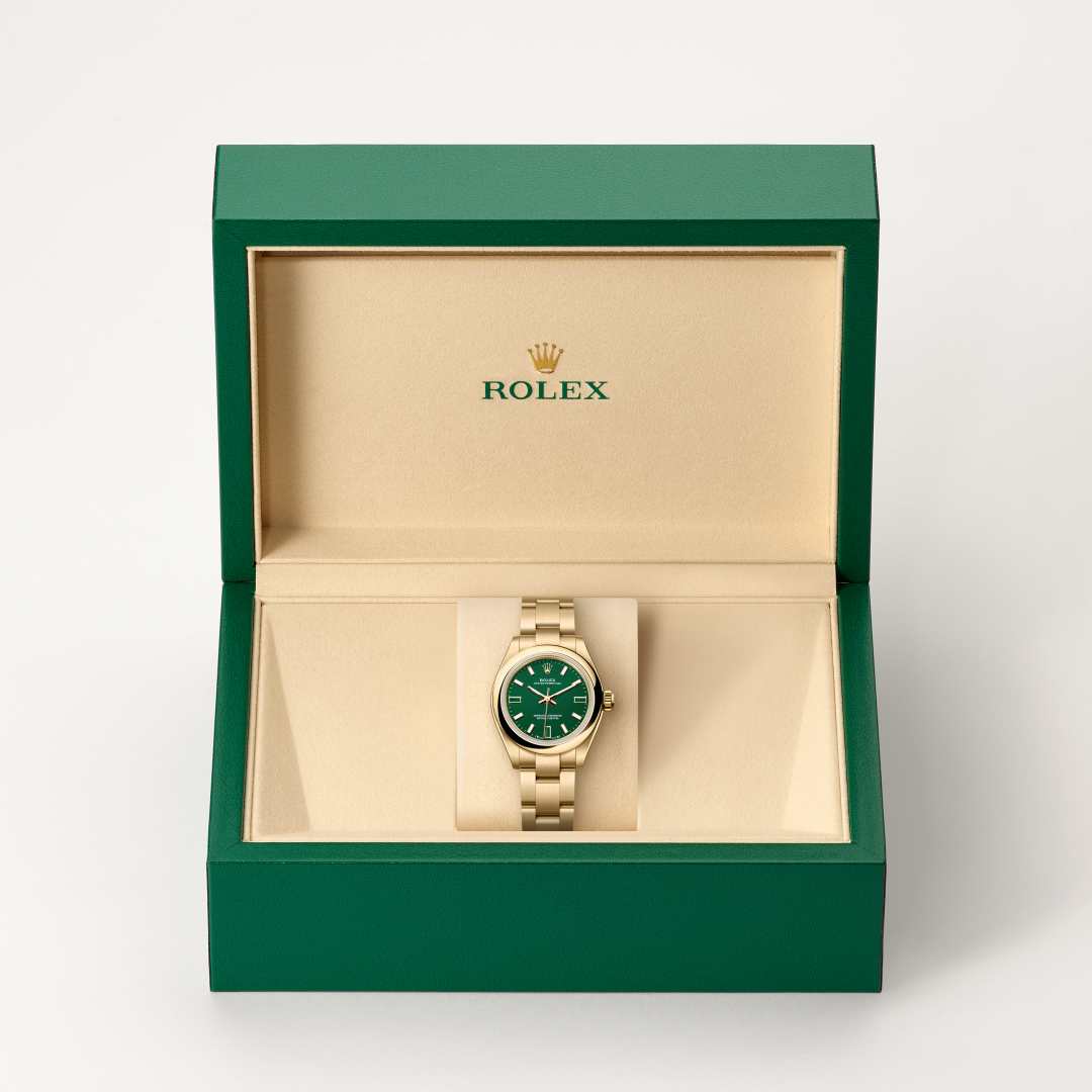 Rolex Oyster Perpetual 28 in 18 ct yellow gold with a green stone dial, domed bezel, and Oyster bracelet.