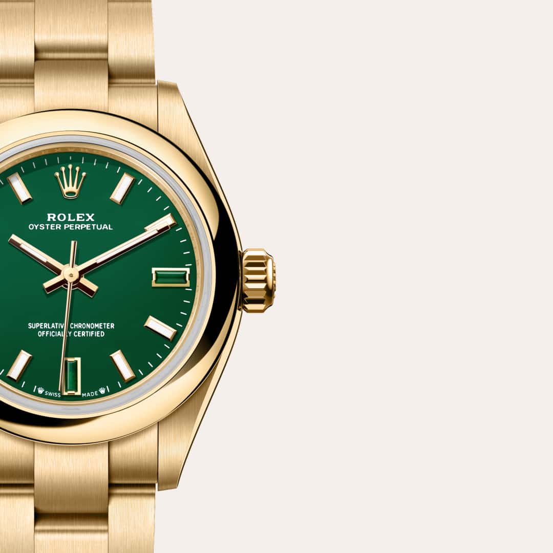 Rolex Oyster Perpetual 28 in 18 ct yellow gold with a green stone dial, domed bezel, and Oyster bracelet.