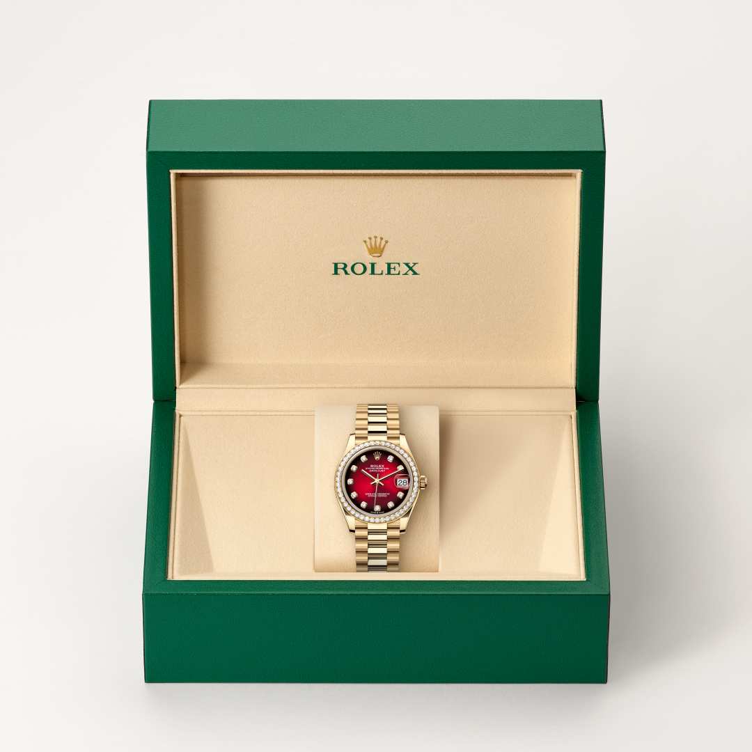 Rolex Datejust 31 in 18 kt yellow gold with a red ombré set with diamonds dial, set with diamonds bezel, and President bracelet.