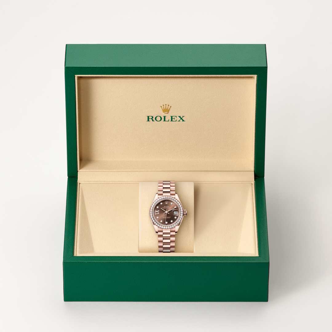Rolex Lady-Datejust in 18 kt Everose gold with a chocolate set with diamonds dial, set with diamonds bezel, and President bracelet.