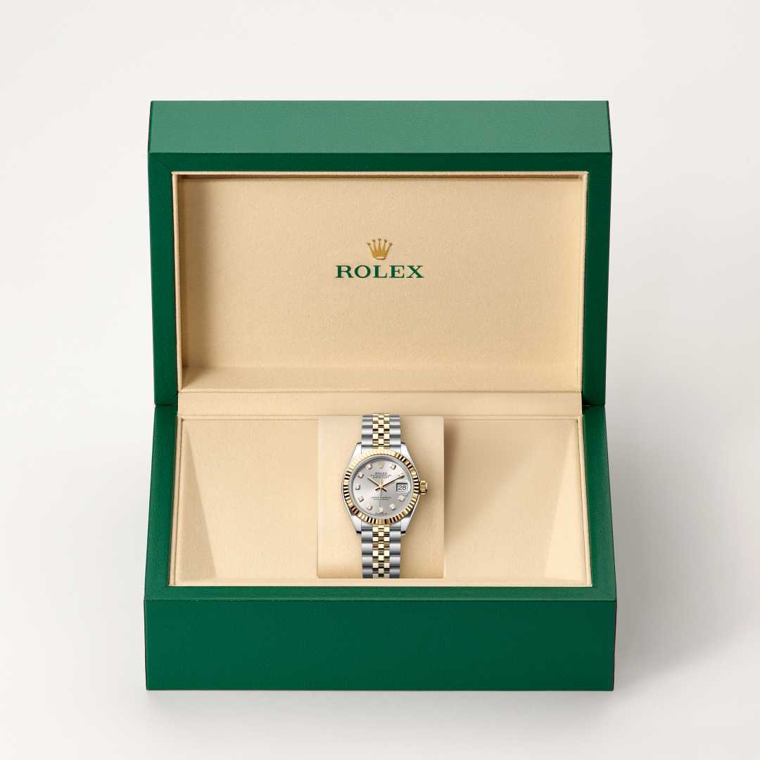Rolex Lady-Datejust in Yellow Rolesor with a silver set with diamonds dial, fluted bezel, and Jubilee bracelet.