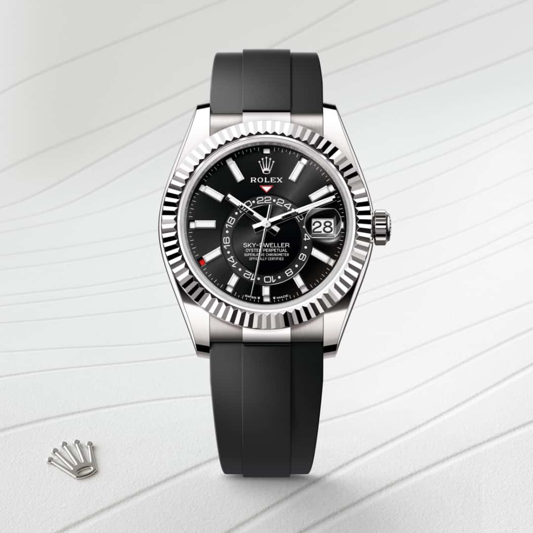 Rolex Sky-Dweller in 18 kt white gold with a bright black dial, fluted, bidirectional rotatable rolex ring command bezel, and Oysterflex bracelet.