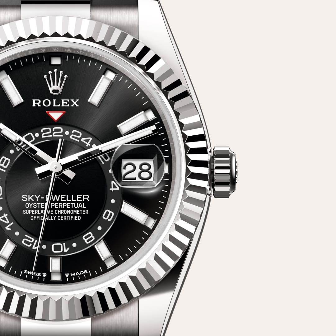 Rolex Sky-Dweller in 18 kt white gold with a bright black dial, fluted, bidirectional rotatable rolex ring command bezel, and Oysterflex bracelet.