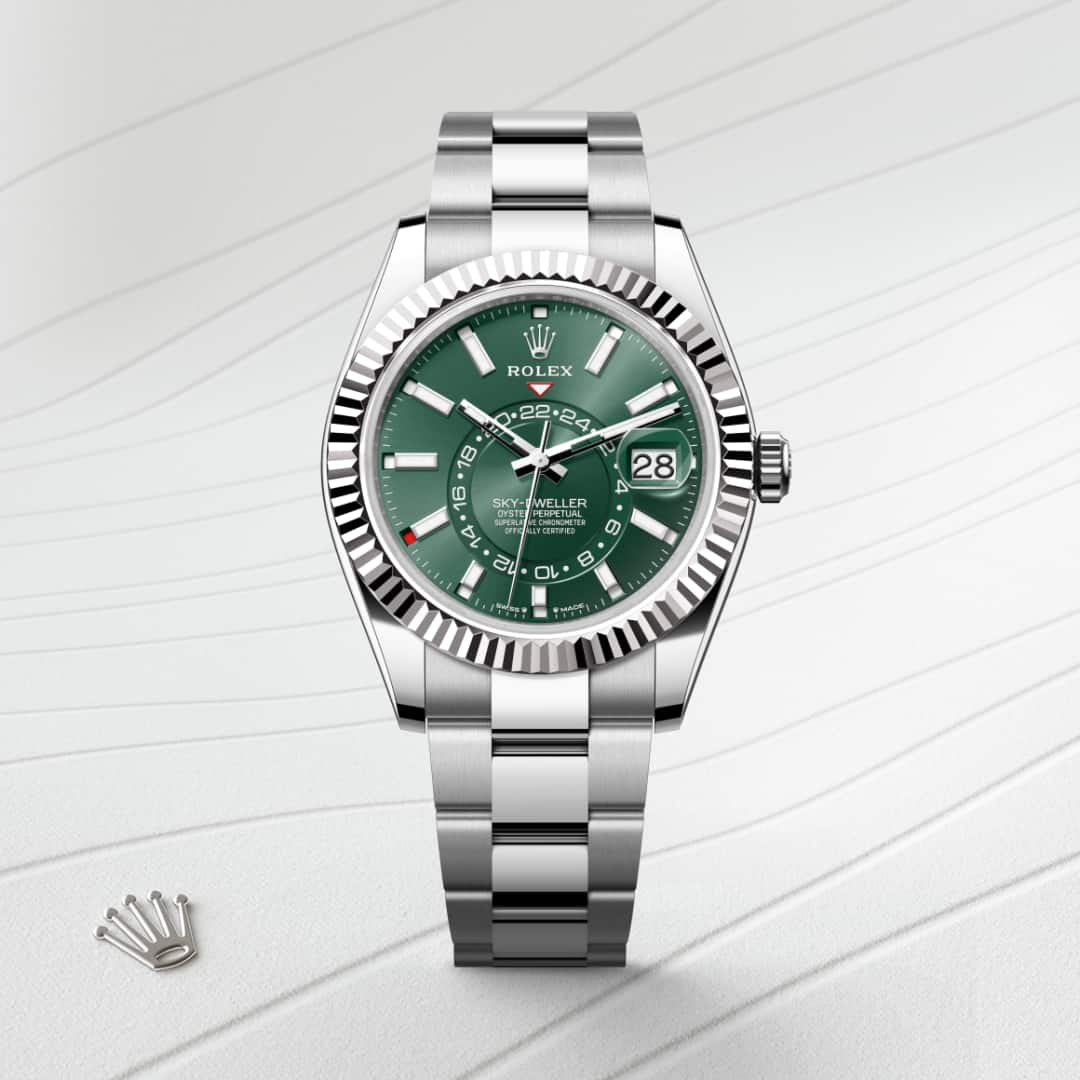 Rolex Sky-Dweller in White Rolesor with a mint green dial, fluted, bidirectional rotatable rolex ring command bezel, and Oyster bracelet.