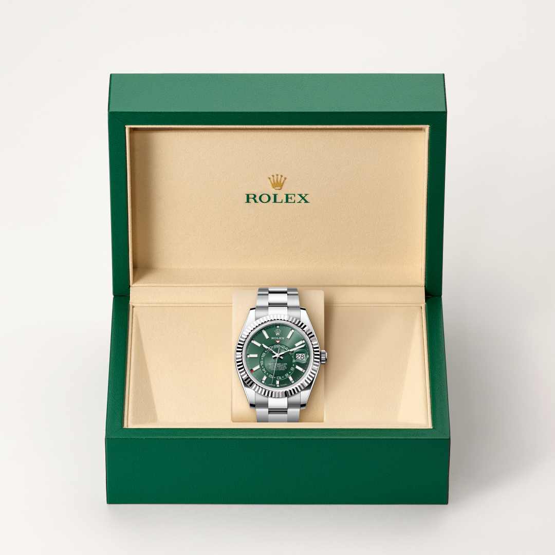 Rolex Sky-Dweller in White Rolesor with a mint green dial, fluted, bidirectional rotatable rolex ring command bezel, and Oyster bracelet.