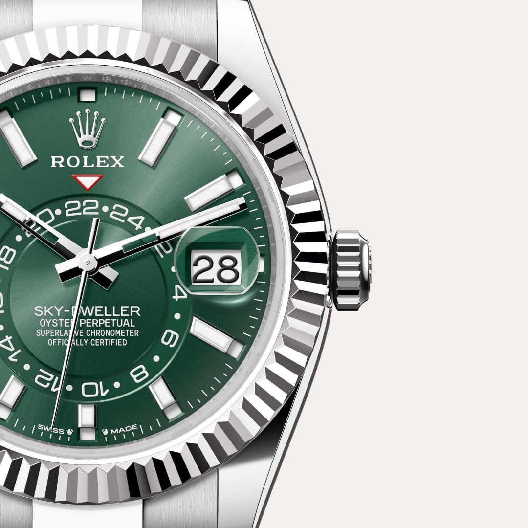 Rolex Sky-Dweller in White Rolesor with a mint green dial, fluted, bidirectional rotatable rolex ring command bezel, and Oyster bracelet.