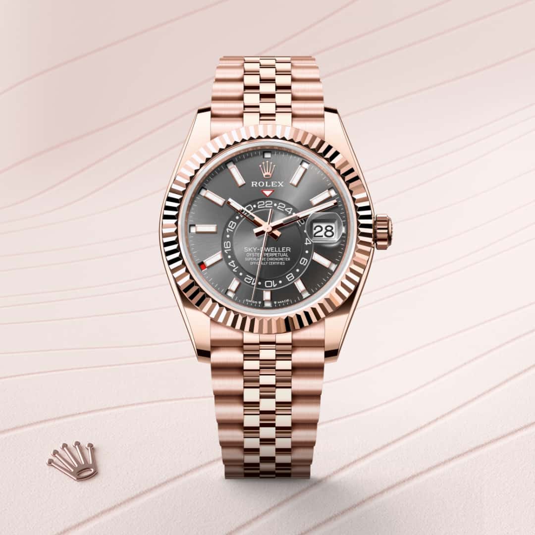 Rolex Sky-Dweller in 18 kt Everose gold with a slate dial, fluted, bidirectional rotatable rolex ring command bezel, and Jubilee bracelet.