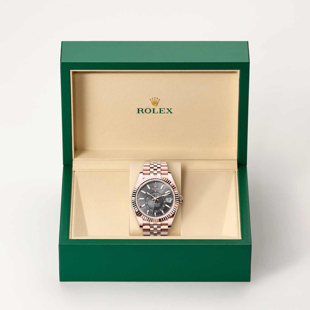 Rolex Sky-Dweller in 18 kt Everose gold with a slate dial, fluted, bidirectional rotatable rolex ring command bezel, and Jubilee bracelet.