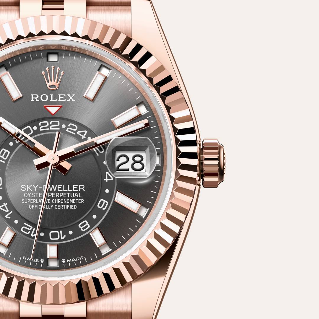 Rolex Sky-Dweller in 18 kt Everose gold with a slate dial, fluted, bidirectional rotatable rolex ring command bezel, and Jubilee bracelet.