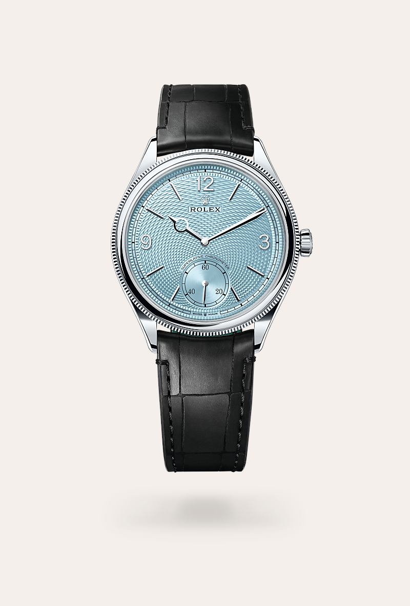 Rolex 1908 in Platinum with a ice blue, rice-grain motif dial, domed and fluted bezel, and Leather strap bracelet.