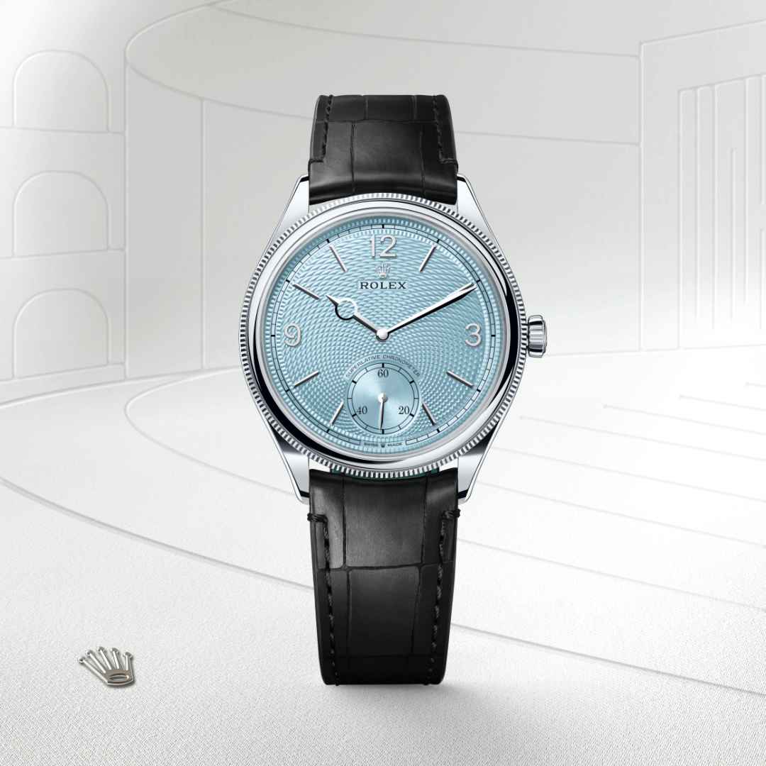 Rolex 1908 in Platinum with a ice blue, rice-grain motif dial, domed and fluted bezel, and Leather strap bracelet.