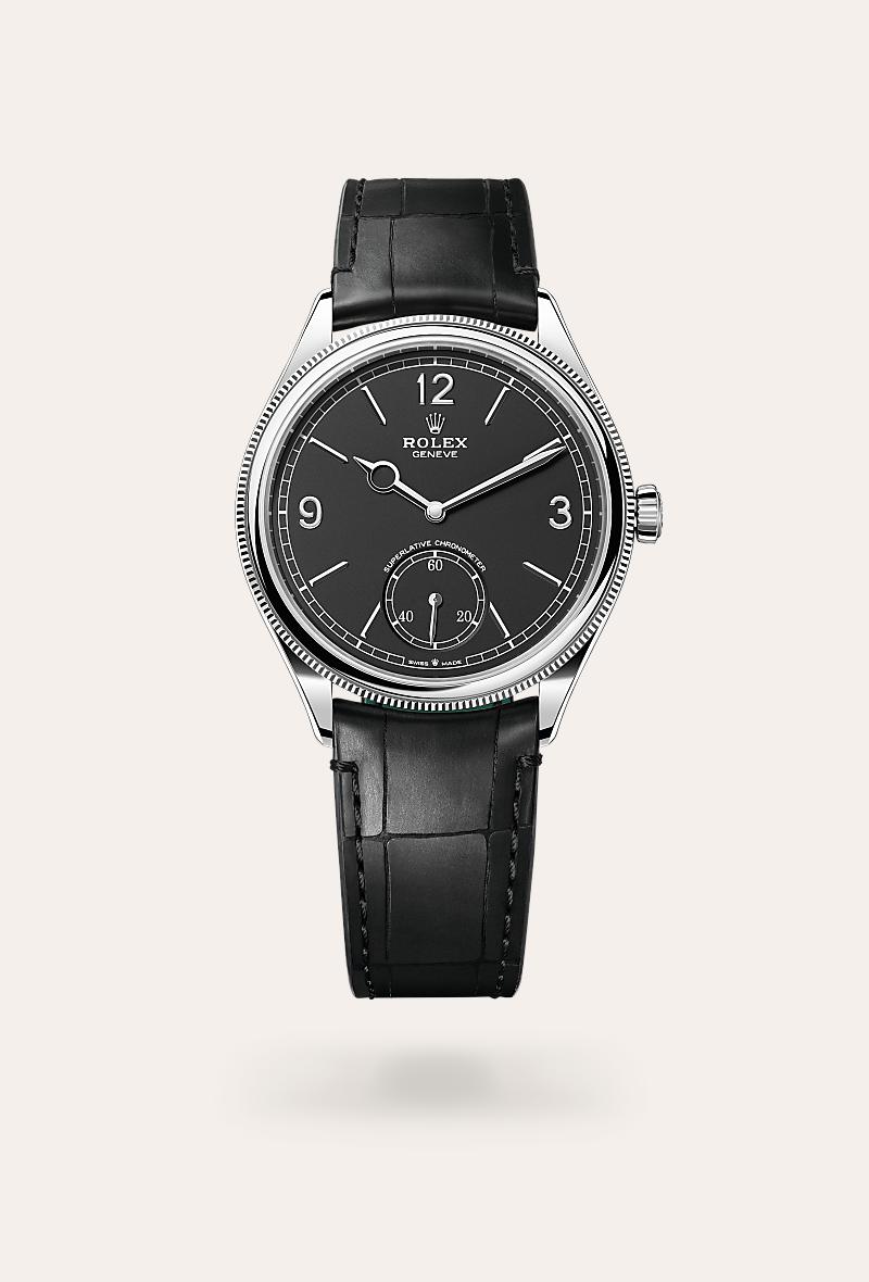 Rolex 1908 in 18 kt white gold with a intense black dial, domed and fluted bezel, and Leather strap bracelet.