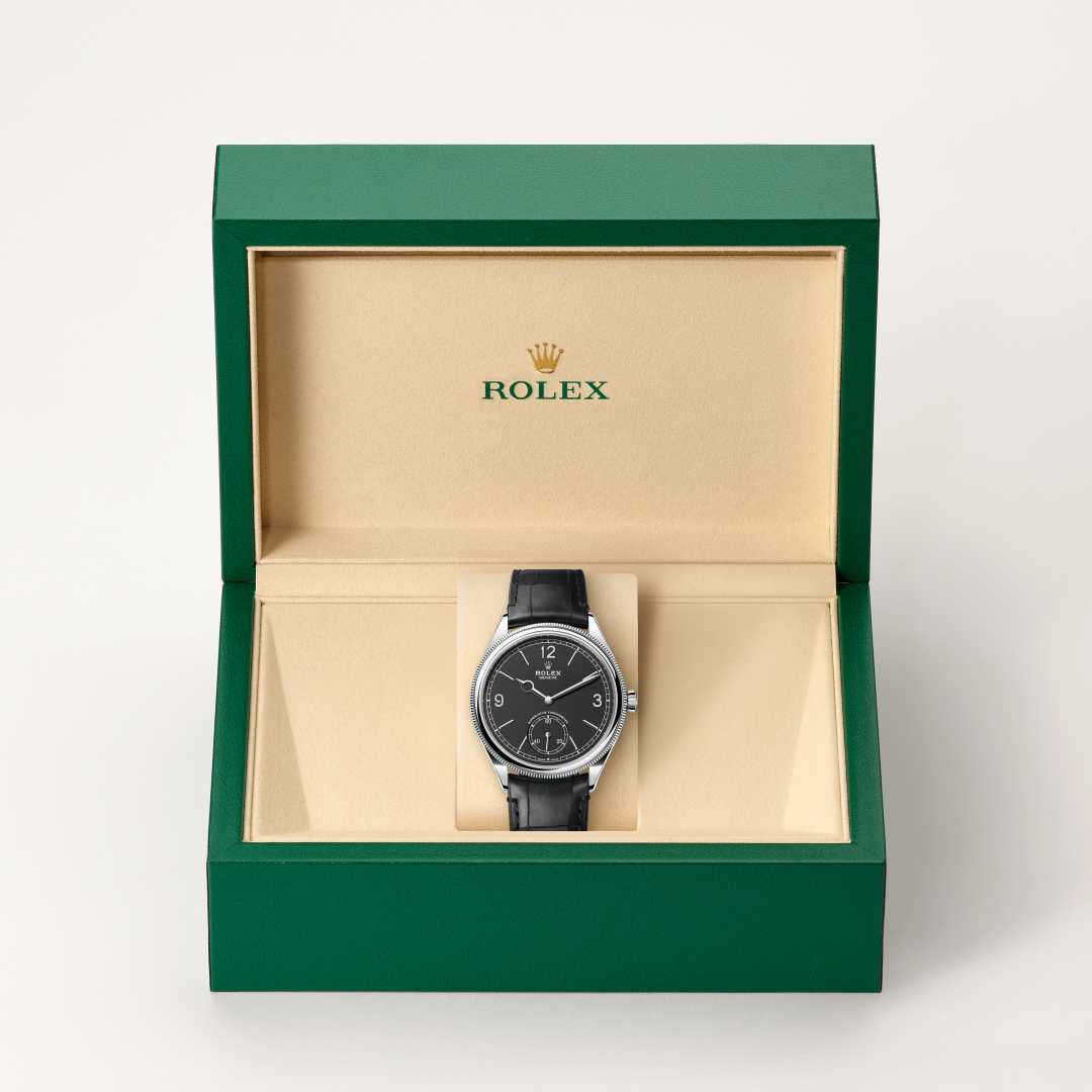 Rolex 1908 in 18 kt white gold with a intense black dial, domed and fluted bezel, and Leather strap bracelet.