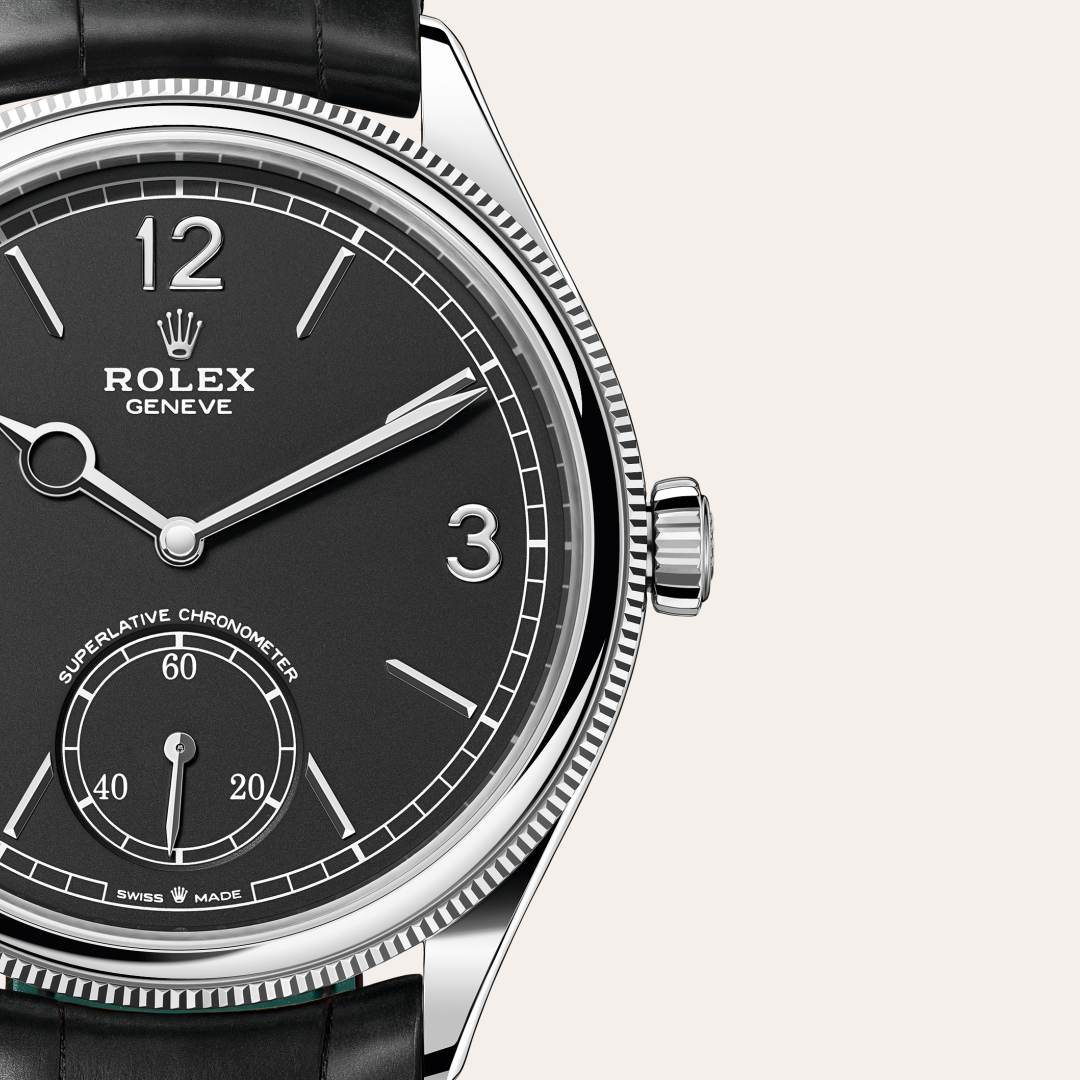 Rolex 1908 in 18 kt white gold with a intense black dial, domed and fluted bezel, and Leather strap bracelet.