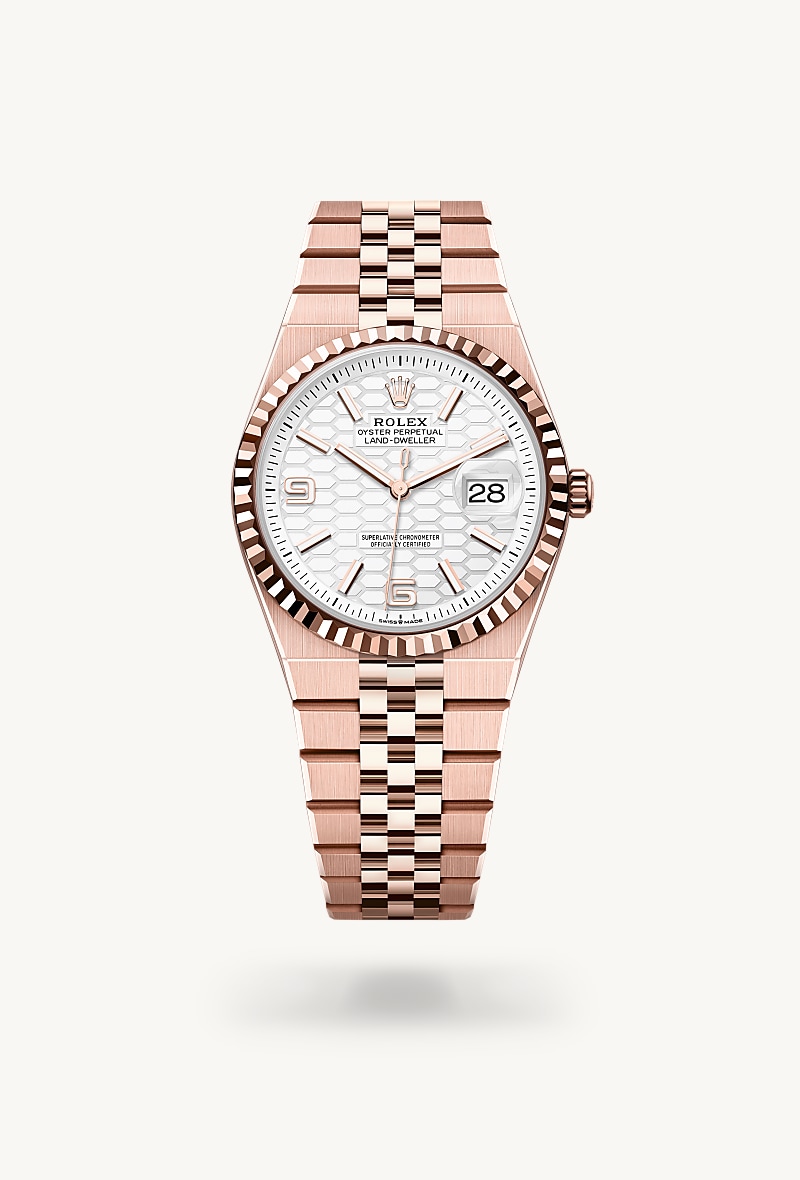 Rolex Land-Dweller 36 in 18 kt Everose gold with a intense white, honeycomb motif dial, fluted bezel, and Flat Jubilee bracelet.