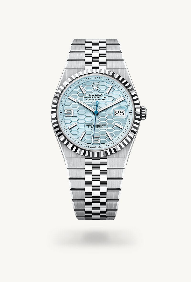 Rolex Land-Dweller 40 in Platinum with a ice blue, honeycomb motif dial, fluted bezel, and Flat Jubilee bracelet.