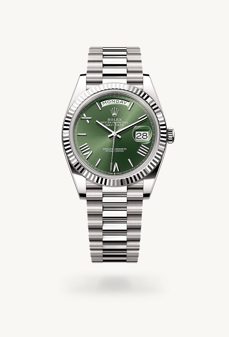 Rolex Day-Date 40 in 18 kt white gold with a olive green dial, fluted bezel, and President bracelet.