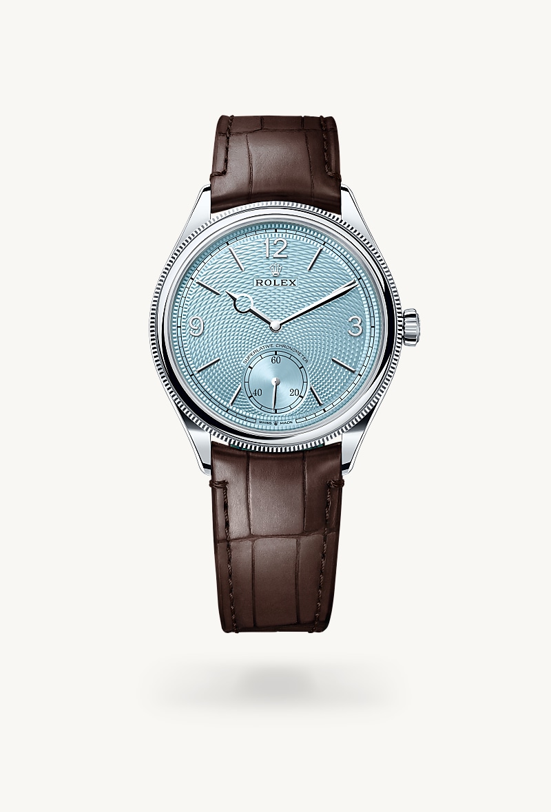 Rolex 1908 in Platinum with a ice blue, rice-grain motif dial, domed and fluted bezel, and Leather strap bracelet.