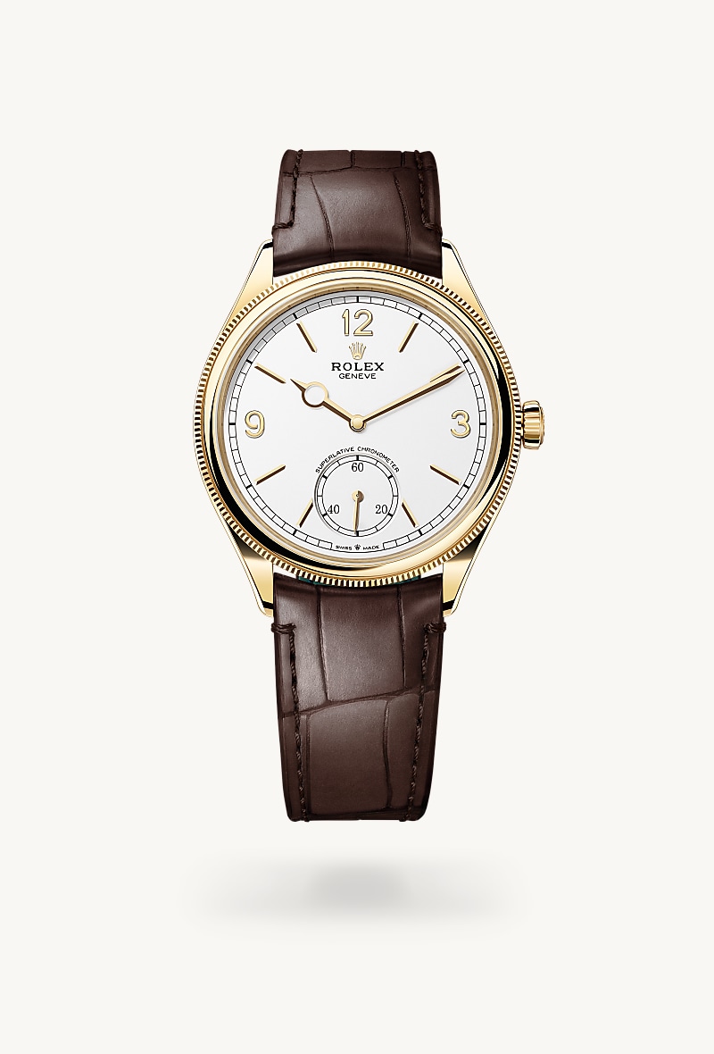 Rolex 1908 in 18 kt yellow gold with a intense white dial, domed and fluted bezel, and Leather strap bracelet.