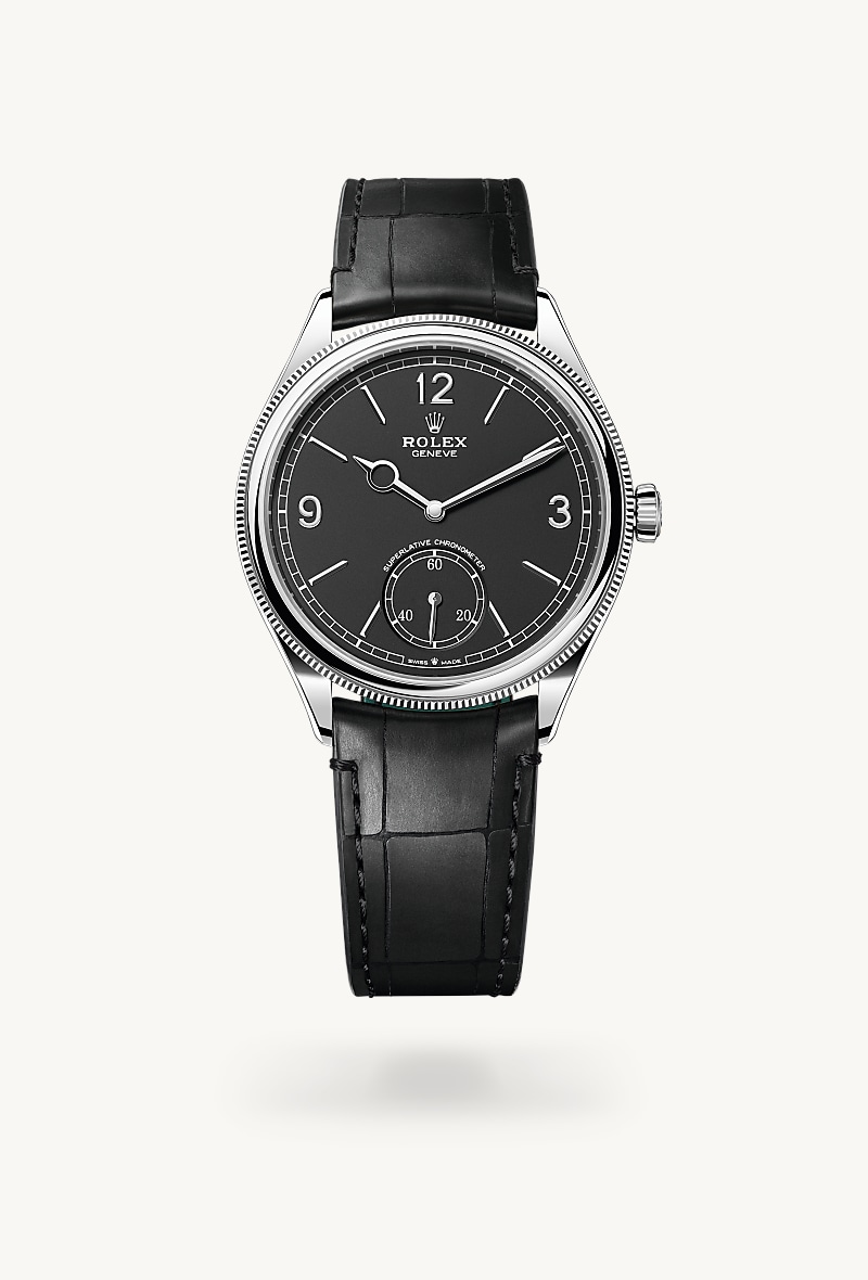 Rolex 1908 in 18 kt white gold with a intense black dial, domed and fluted bezel, and Leather strap bracelet.