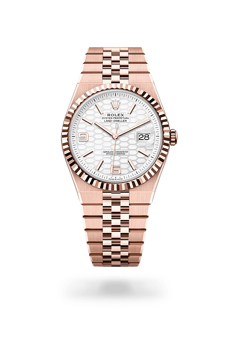 Rolex Land-Dweller 40 in 18 kt Everose gold with a intense white, honeycomb motif dial, fluted bezel, and Flat Jubilee bracelet.