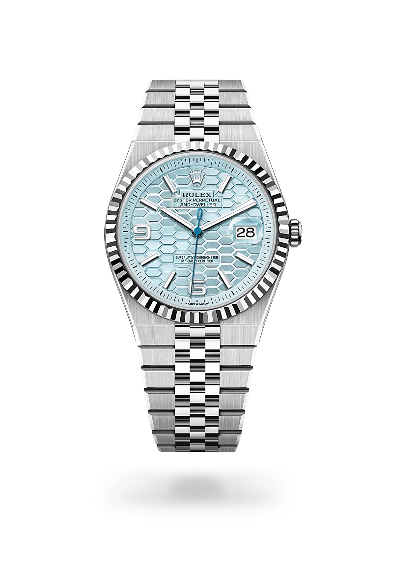Rolex Land-Dweller 40 in Platinum with a ice blue, honeycomb motif dial, fluted bezel, and Flat Jubilee bracelet.